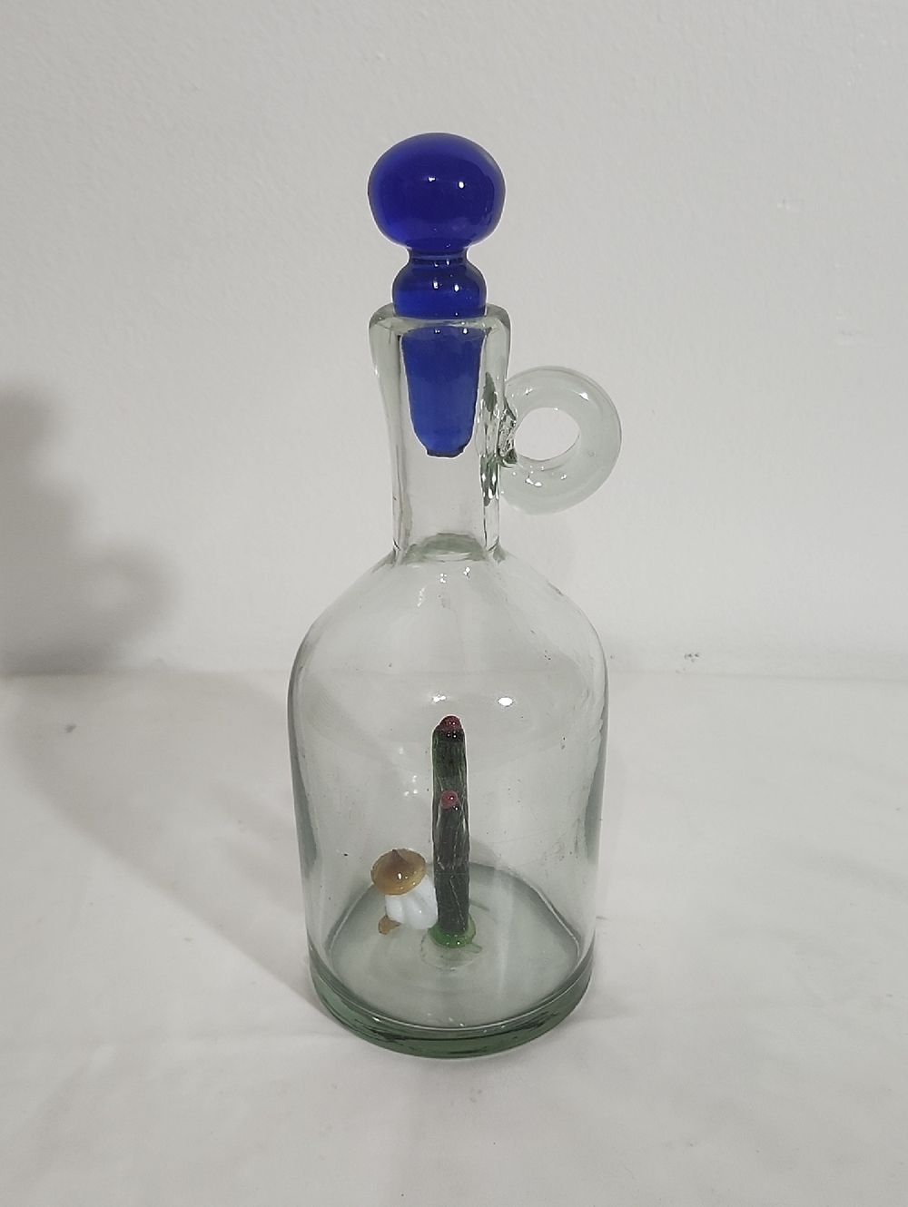 Clear Glass Decorative Bottle with Blue Stopper and Miniature Interior